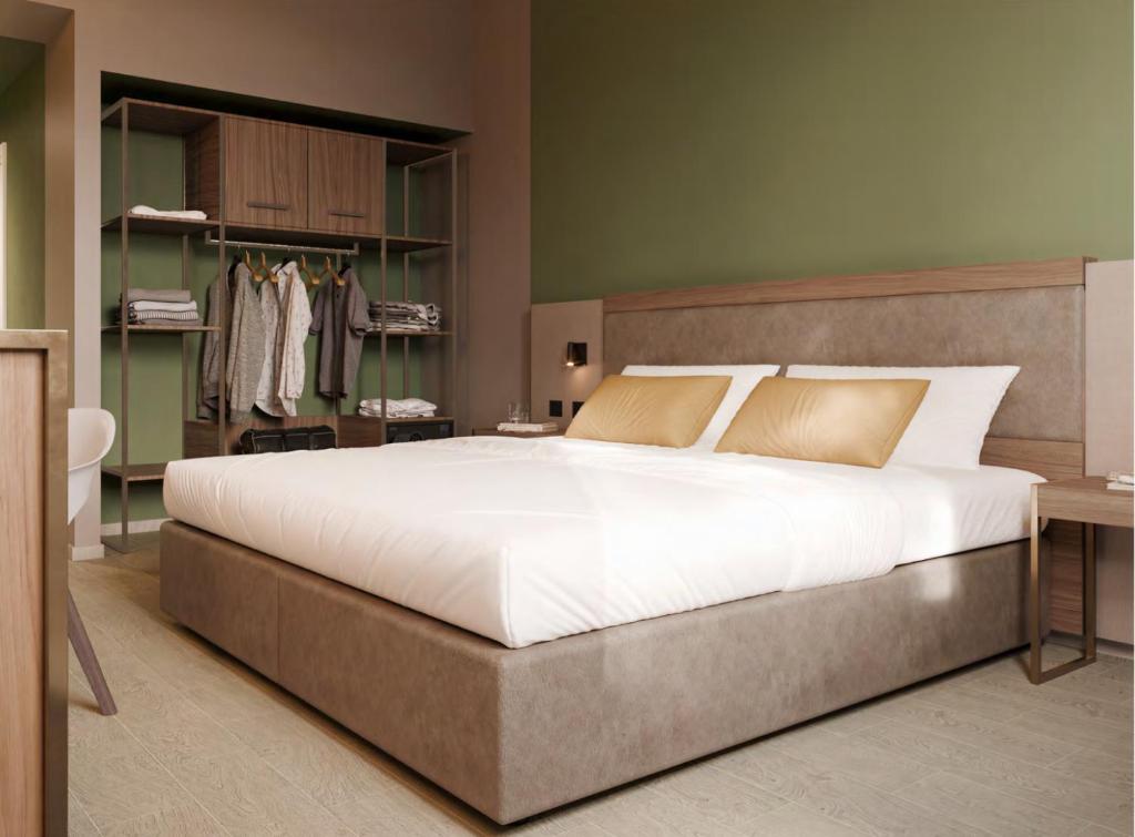 a bedroom with a large bed and a bathroom at LVG Hotel Collection - Belfiore in Mantova