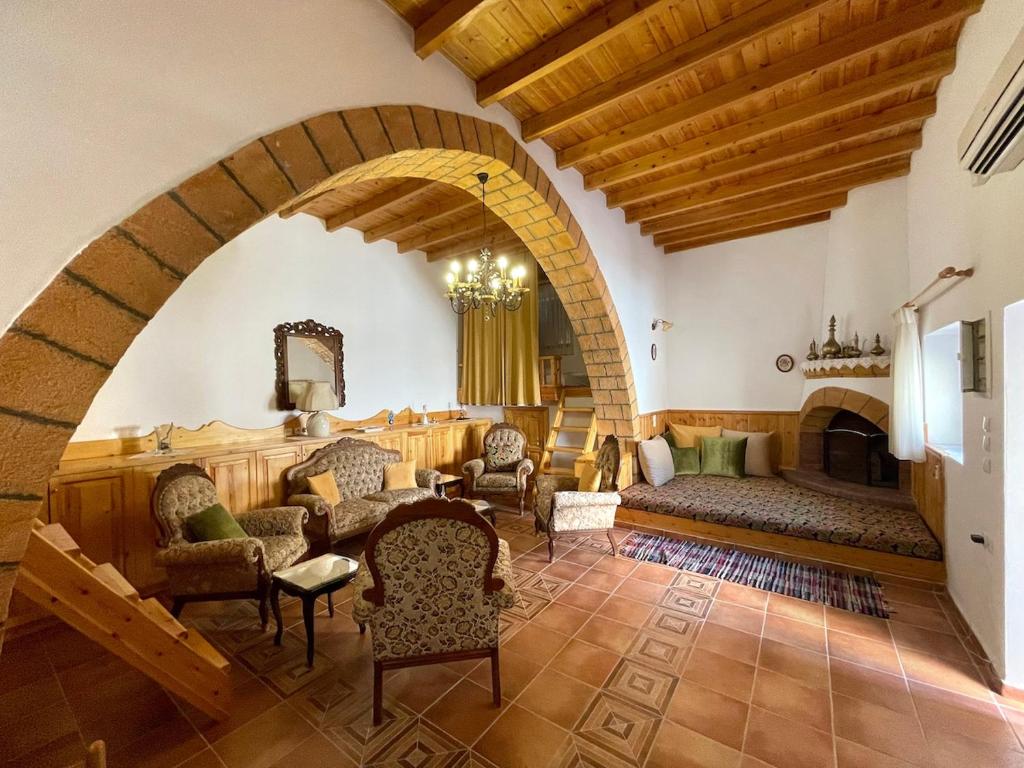 a living room filled with furniture and a fireplace at Traditional Stay in Archangelos