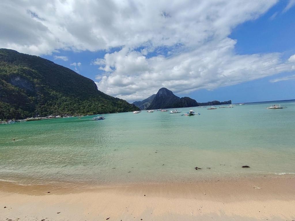 a view of a beach with boats in the water at Gracias Place in El Nido