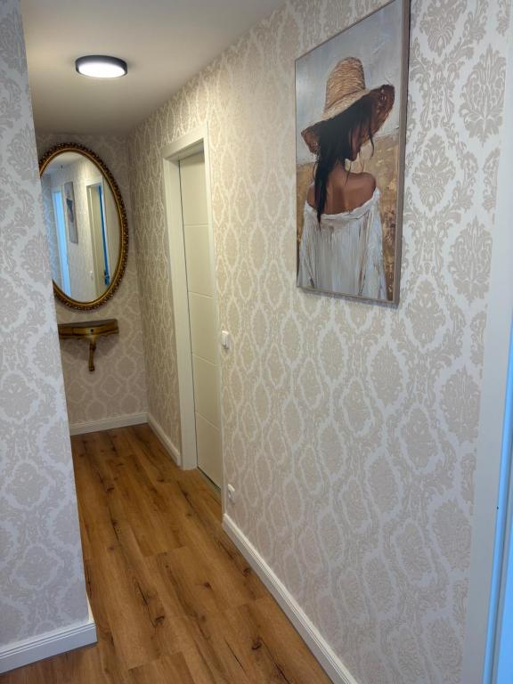 a hallway with a painting of a woman with a hat at Schäferstr 43 in Peine