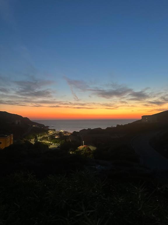 a view of the sunset from the top of a hill at B&B Calata Di Soli in Miniera dellʼArgentiera