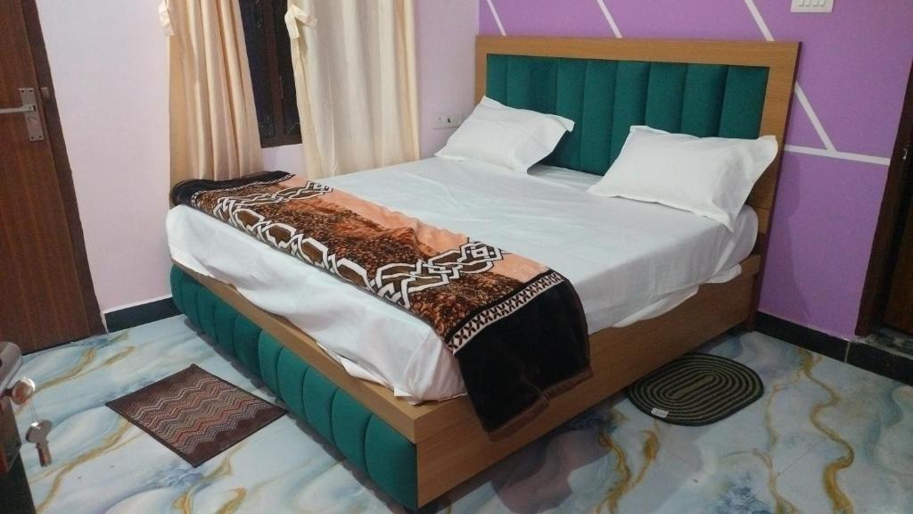 a bedroom with a bed in a room at Hotel Dharma palace in Prayagraj
