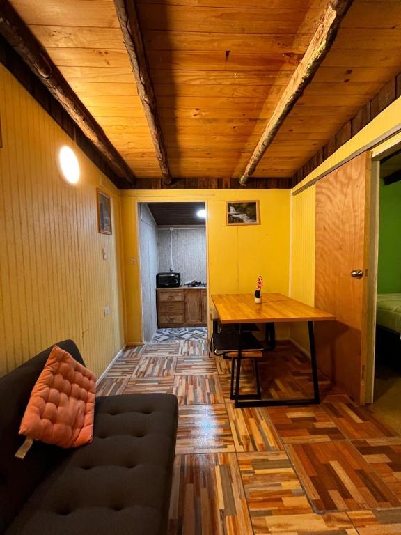 a living room with a table and a couch at Kutral-Ko in Hornopiren