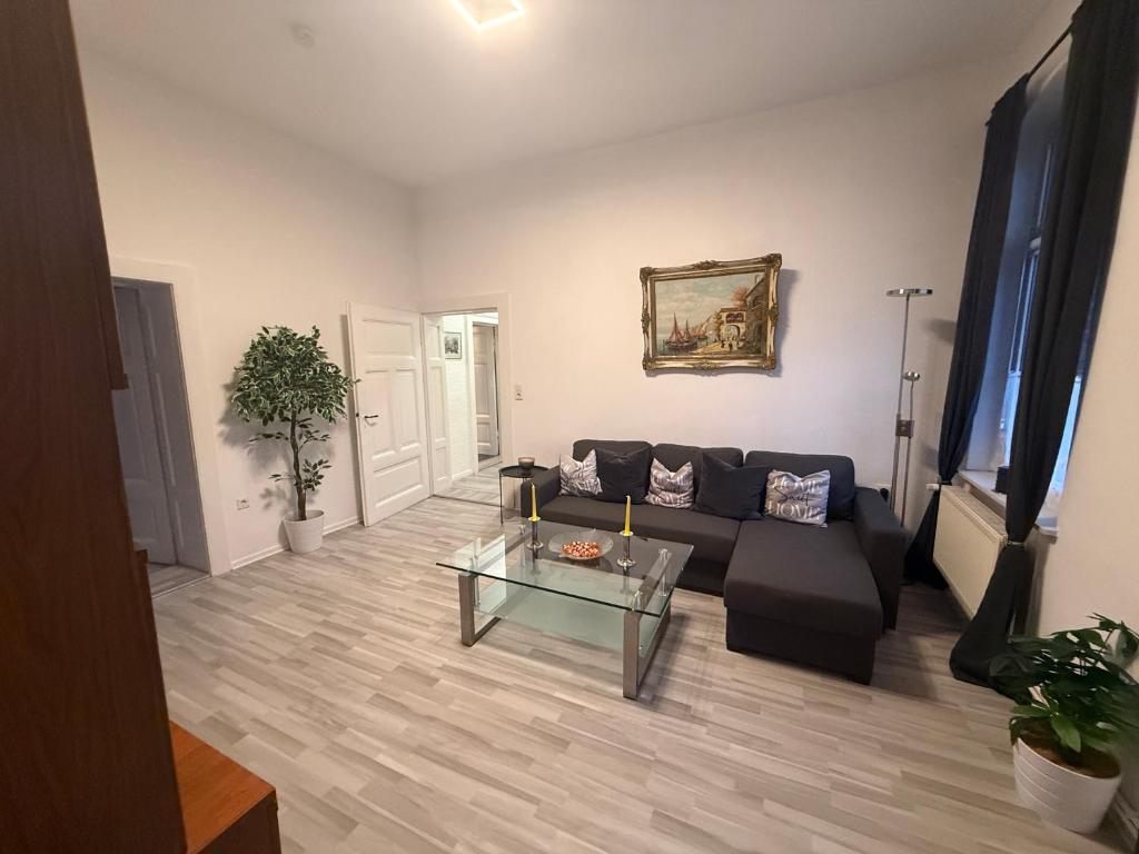 a living room with a couch and a glass table at Ferienwohnung Margrit in Börßum