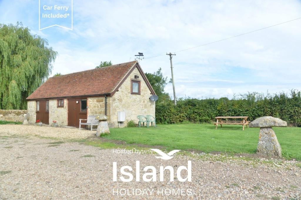 a stone cottage with a garden and a playground at Willows in Calbourne