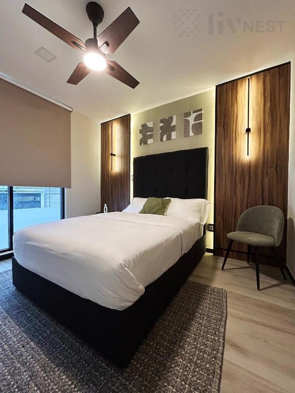 a bedroom with a large bed and a ceiling fan at Quiet Room w/bath + Top Amenities! in La Cañada