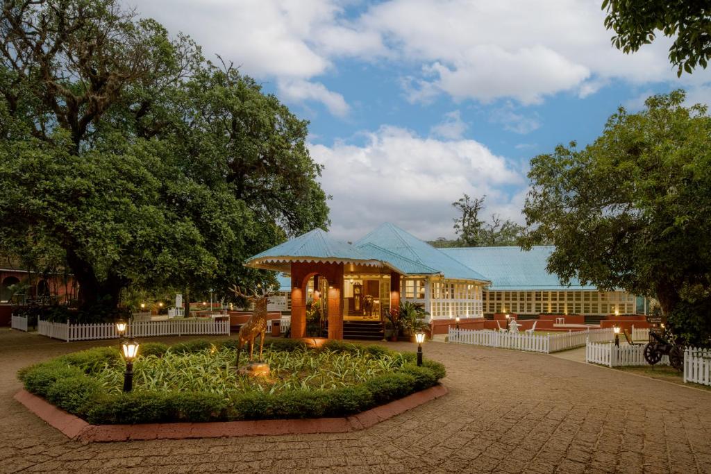 a building with a gazebo with lights in a courtyard at Chambers Mahabaleshwar, A Club Mahindra Associate Resort in Mahabaleshwar