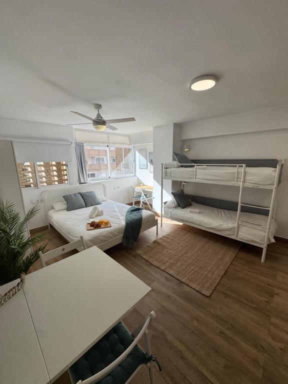 a living room with two bunk beds and a couch at Vacaciones en familia Ap Portitxol en Xàbia in Platja de l'Arenal