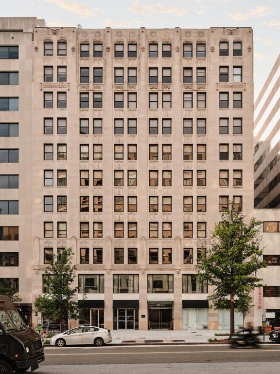 a large building with cars parked in front of it at Mint House Washington Dc Downtown By Kasa in Washington, D.C.