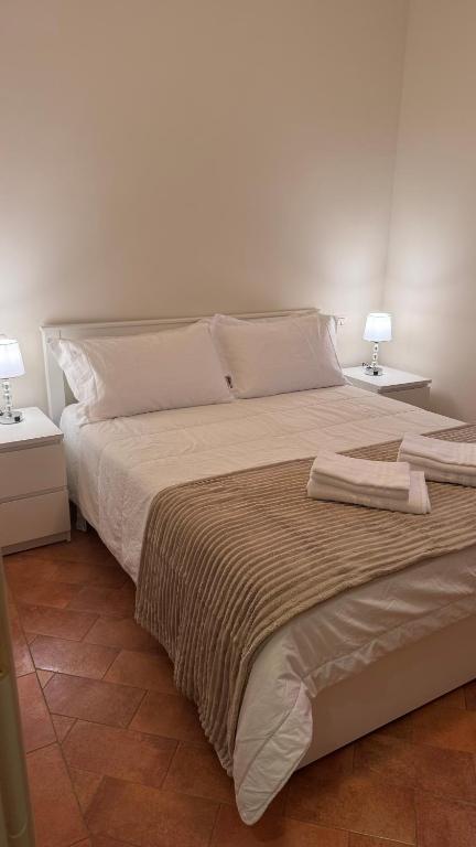 a bedroom with a large bed with two end tables at Casa Rasiglia 2 House Smart in Casenove