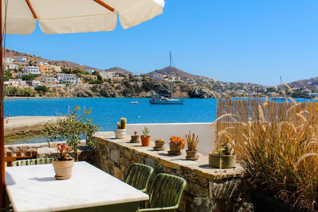 a table and chairs with a view of the water at Almyra in Finikas
