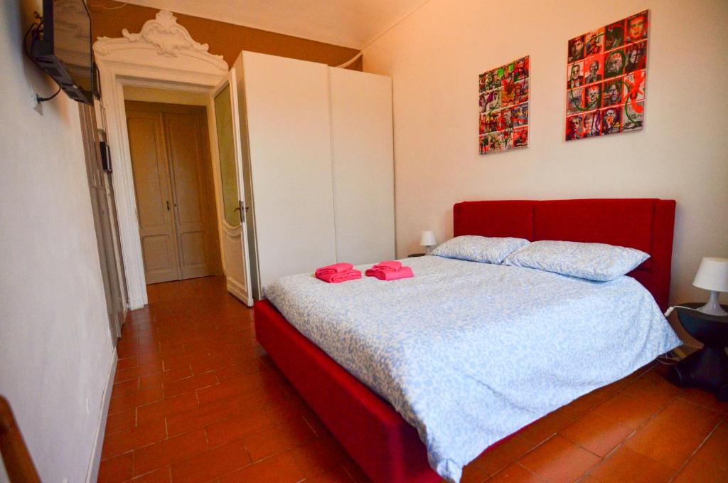 a bedroom with a bed with a red headboard at Cà dla Madamina in Turin