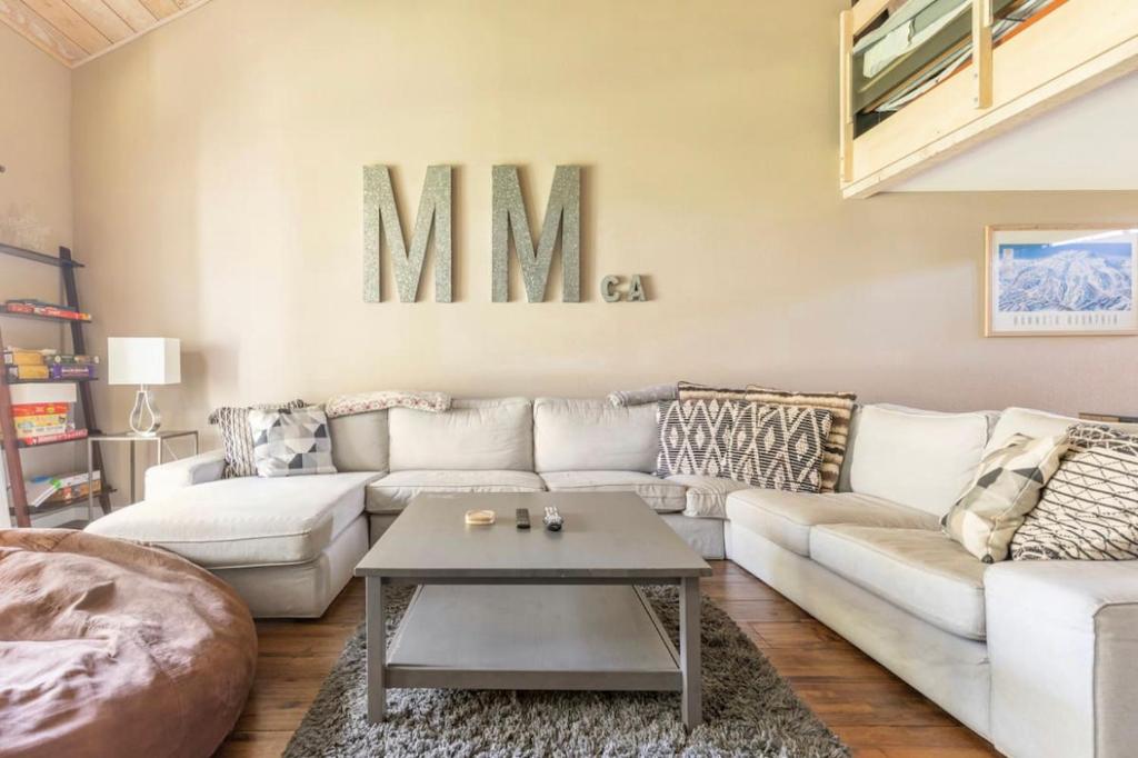 a living room with a couch and a table at Snowcreek 569 in Mammoth Lakes