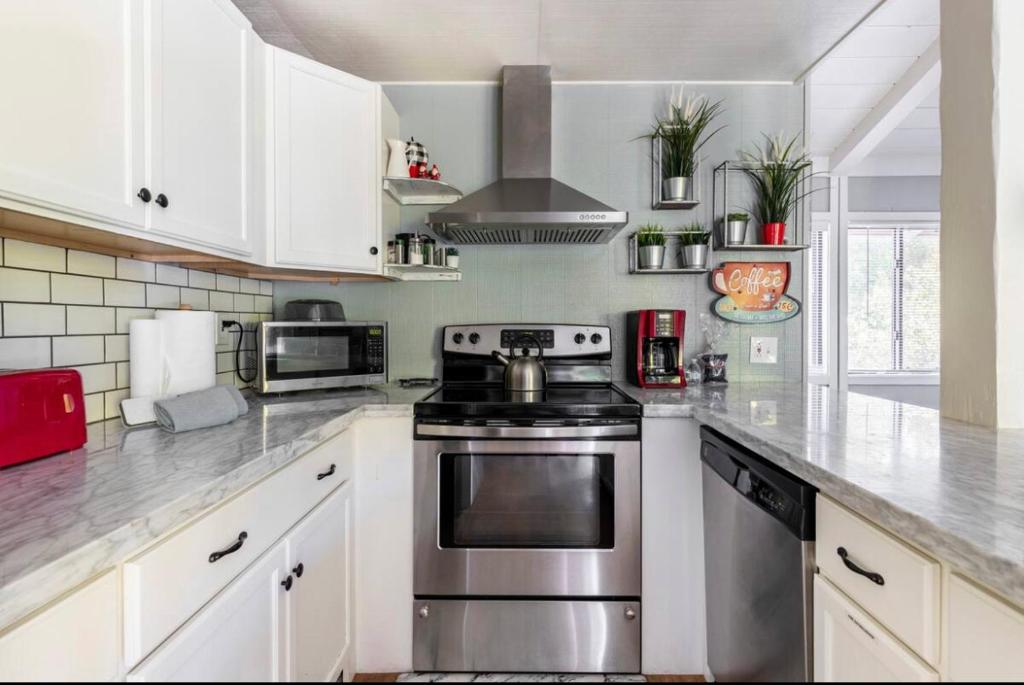 a kitchen with stainless steel appliances and white cabinets at Villa De Los Pinos 15 in Mammoth Lakes
