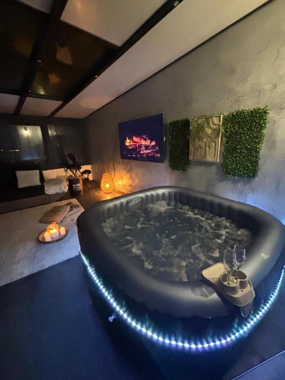 a large bath tub in a room with a tv at L abricosy in Drancy