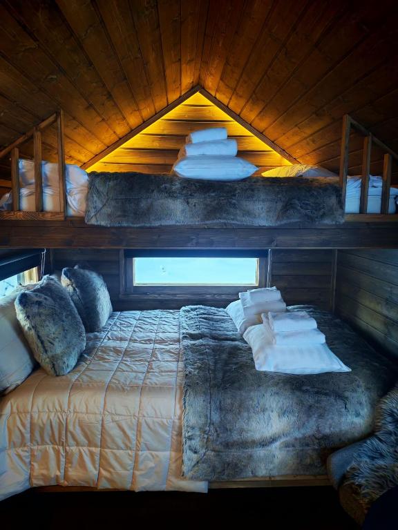 a bedroom with a bed with pillows on it at Arctic circle cabin 3 in Rovaniemi