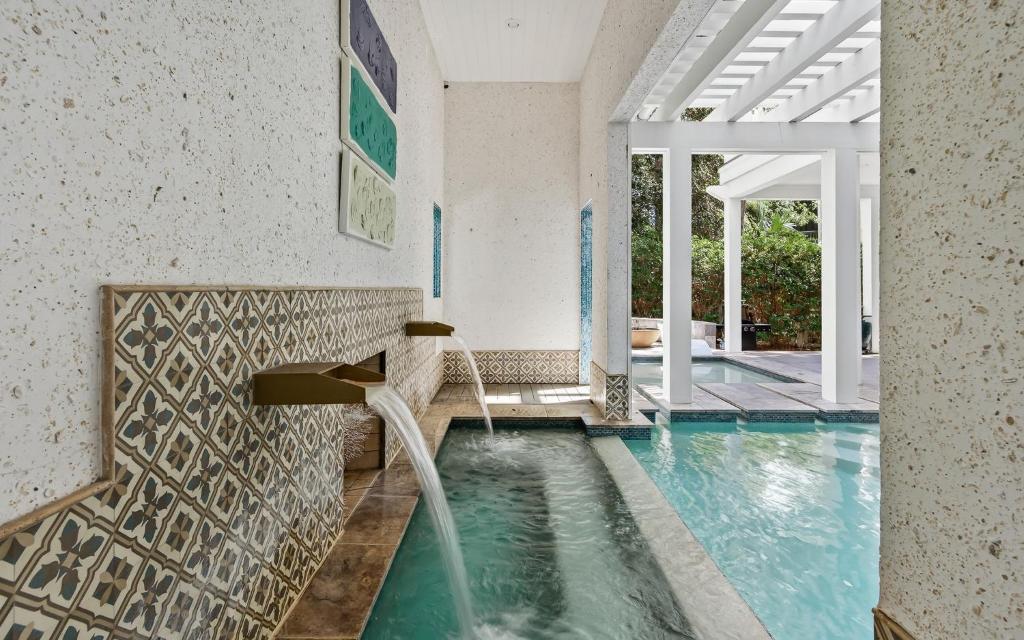 a swimming pool with a fountain in a house at Watercolor Reunions in Santa Rosa Beach