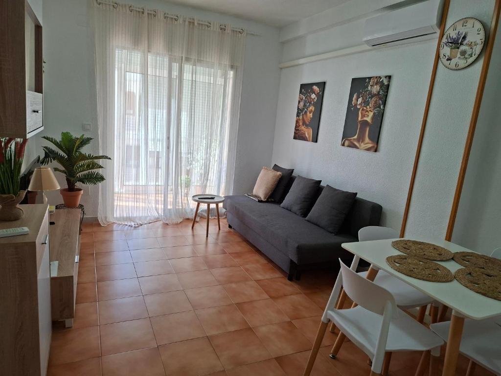 a living room with a couch and a table at Casas Holiday - Playa la Mata Laredo in La Mata