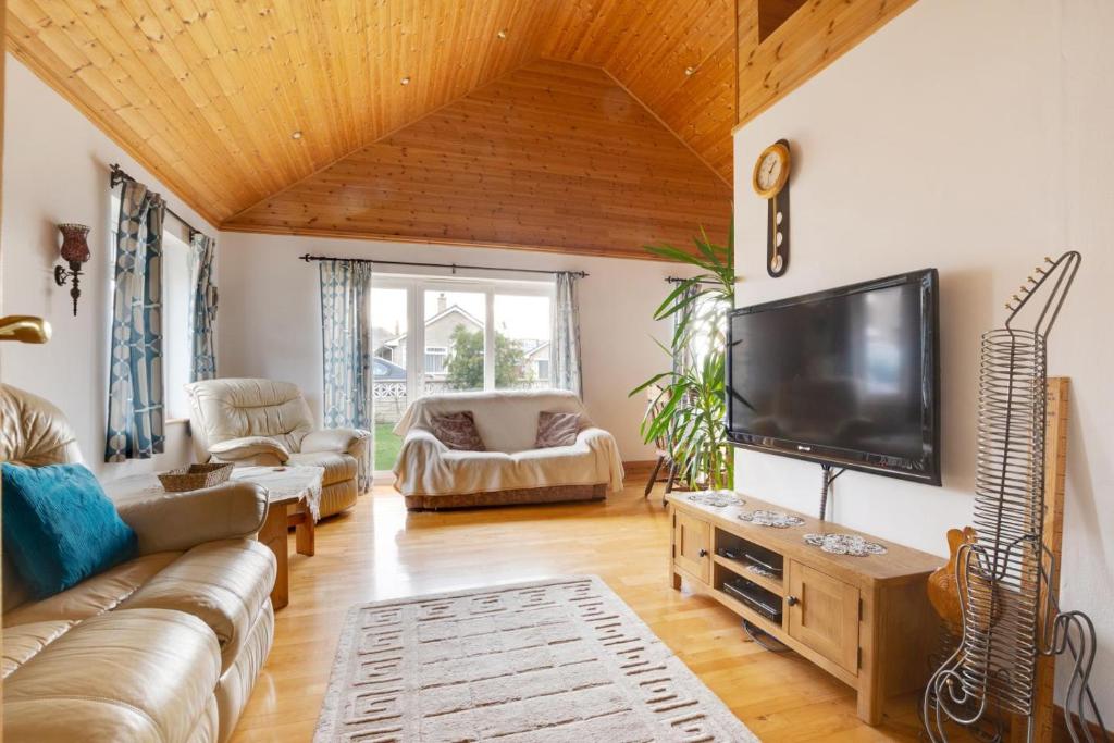 a living room with a couch and a flat screen tv at 2 Bed in Staithes oc-wa071 in Staithes