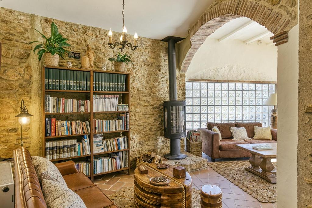 a living room with a book shelf filled with books at Can Barrull-Costa Brava-Emporda in San Felíu de Boada