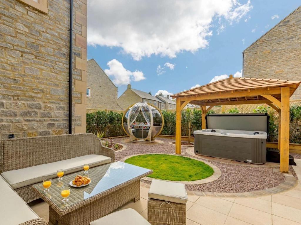 a patio with a barbecue grill and a gazebo at 4 Bed in Hope Valley oc-89431 in Bradwell