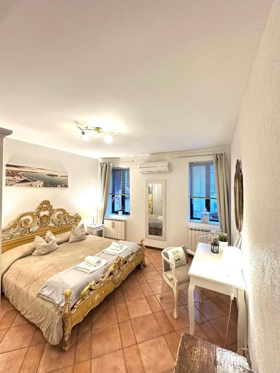 a bedroom with a large bed and a table at Caterina Biennale Apartment in Venice