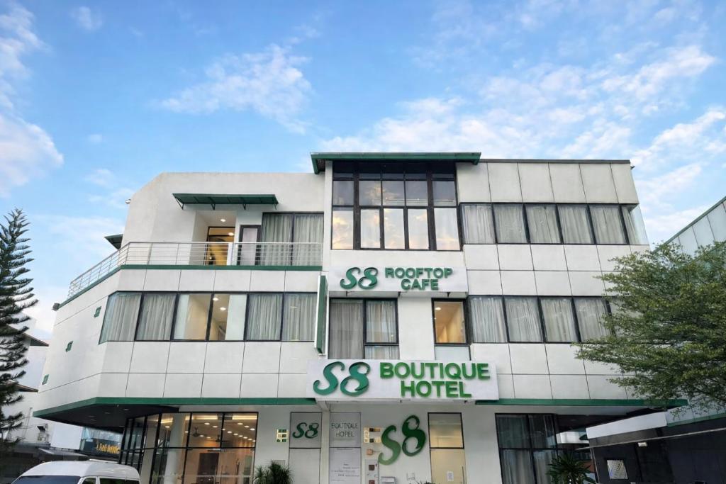 a large white building with a sign on it at S8 Boutique Hotel near KLIA 1 & KLIA 2 in Sepang