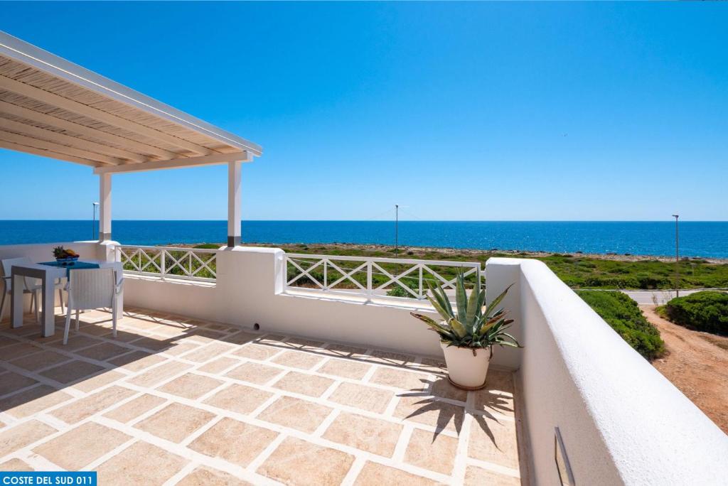 a balcony with a view of the ocean at Residence Salento Fronte Mare - Coste del Sud it in Torre San Giovanni Ugento