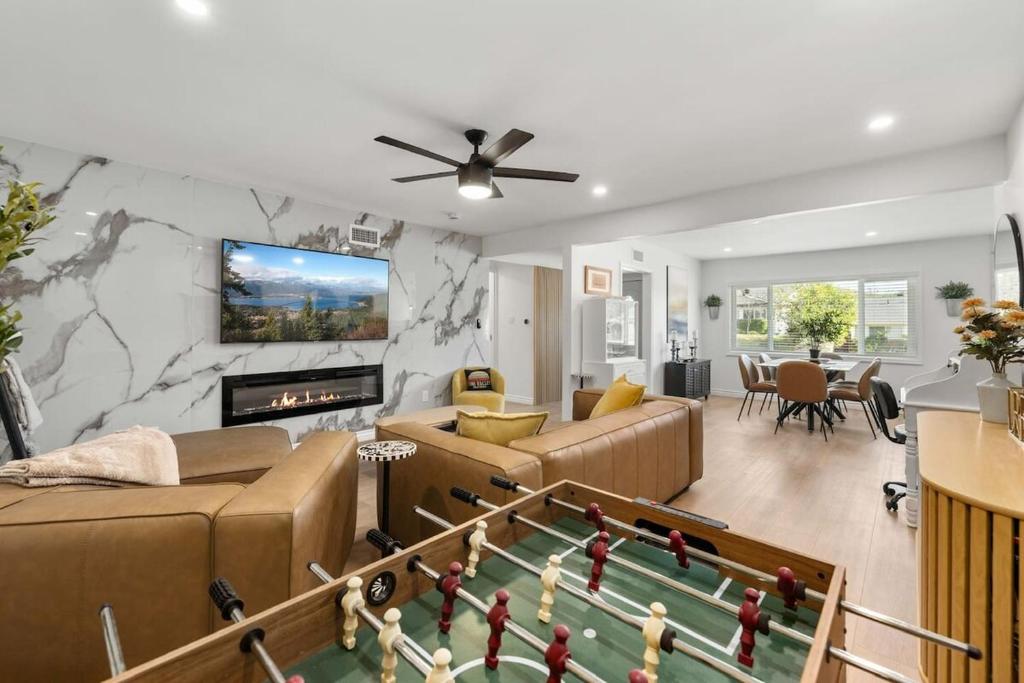 a living room with a couch and a pool table at Private 3BR Home - Hot Tub, Yard, Arcade & Parking in Simi Valley