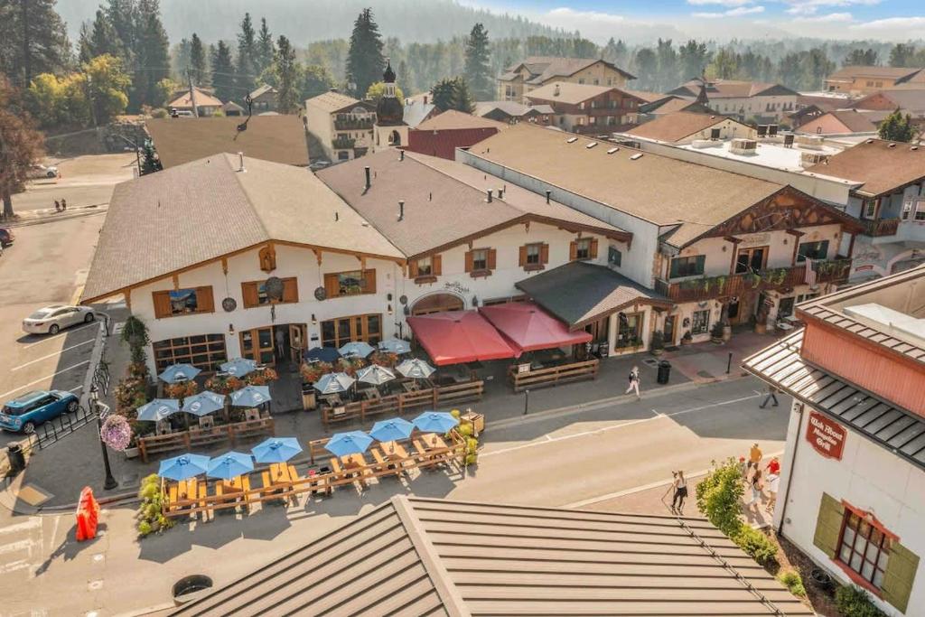 an overhead view of a town with tables and umbrellas at Front Street Suites - Pacific Retreats in Leavenworth
