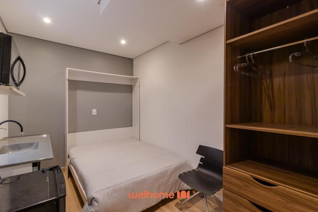 a small bedroom with a bed and a sink at Apartamento no tradicional Bairro do Bixiga em SP in São Paulo