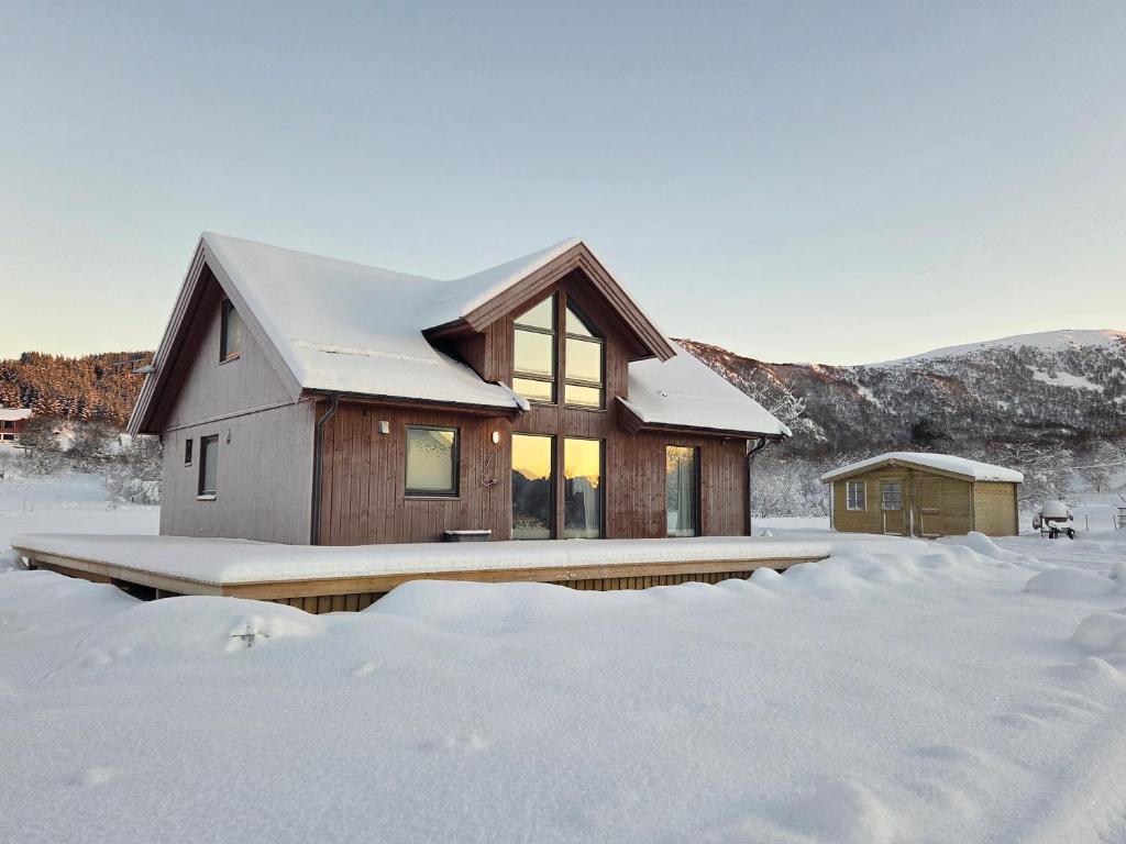 a house in the snow with snow covered at Harteigen cabin Lofoten retreat in Vestvågøya