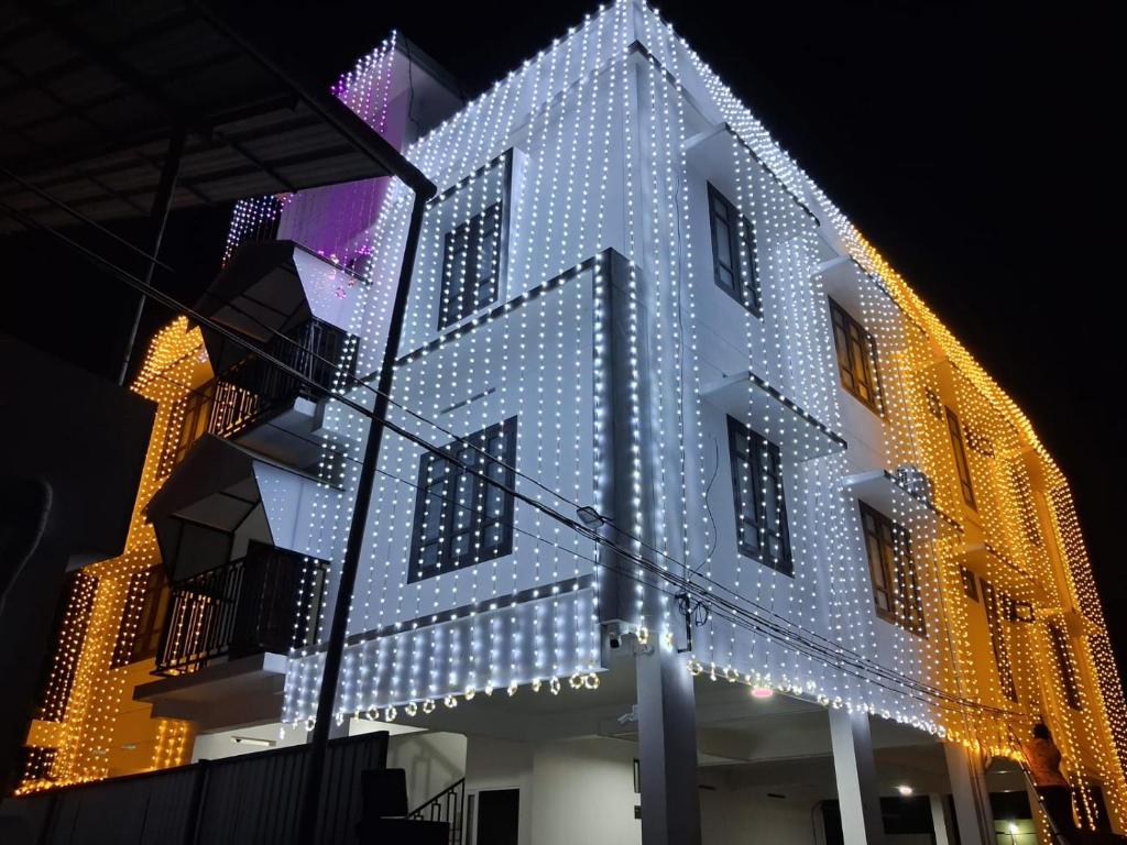 a building decorated with christmas lights at night at Enpathil Residency in Kollam