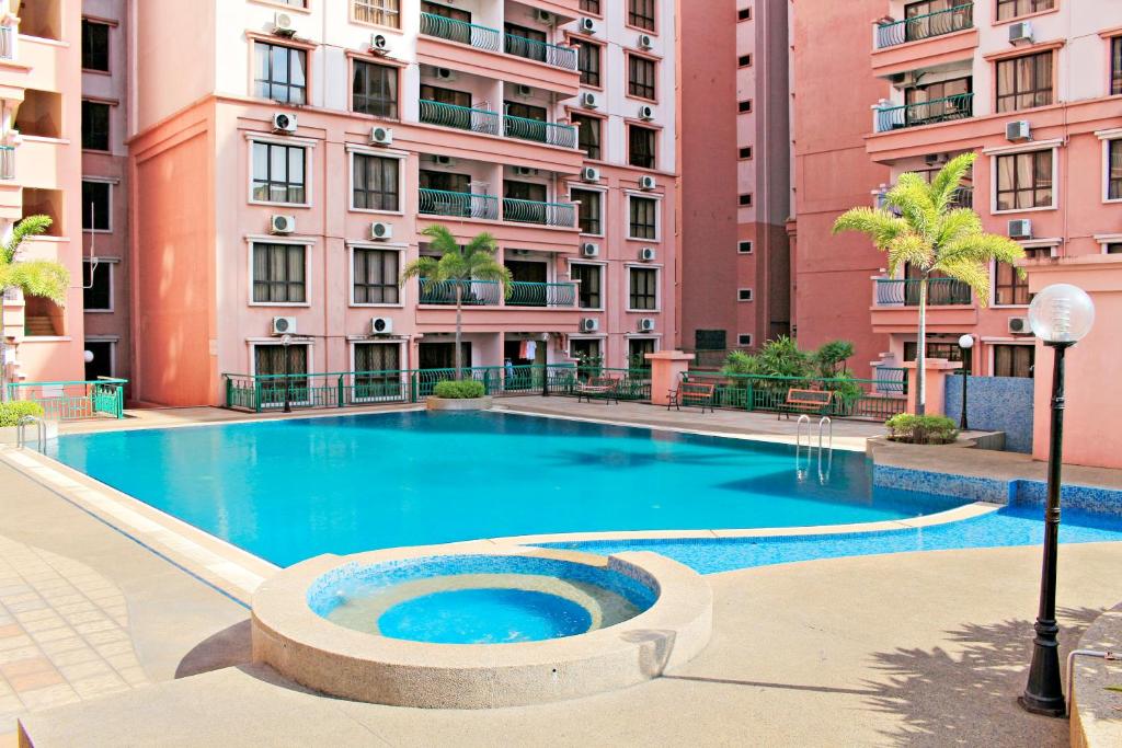 a large swimming pool in front of a building at Homestay Marina Court Resort in Kota Kinabalu
