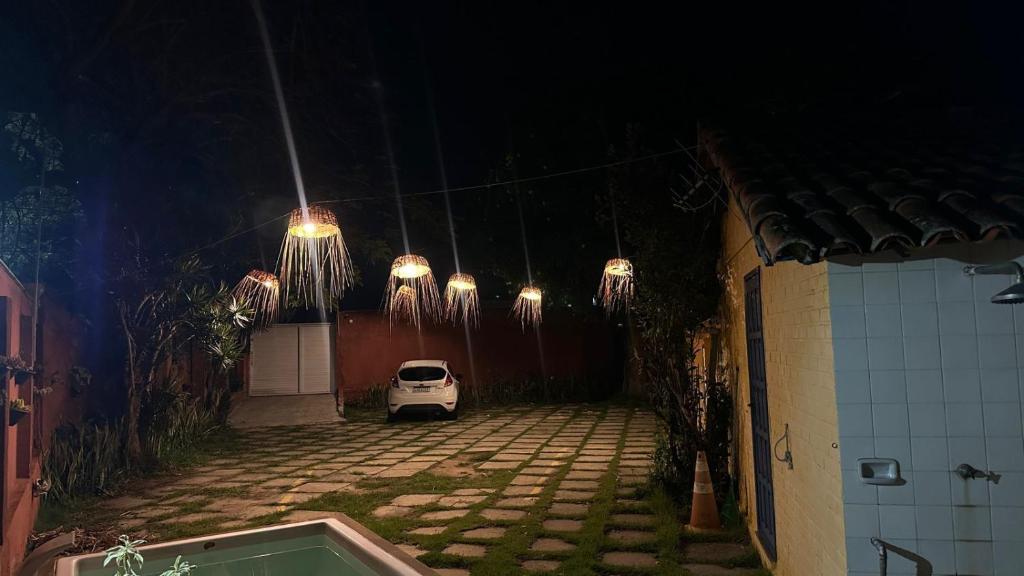 a small car parked in a parking lot at night at Iago Pousada in Cabo Frio