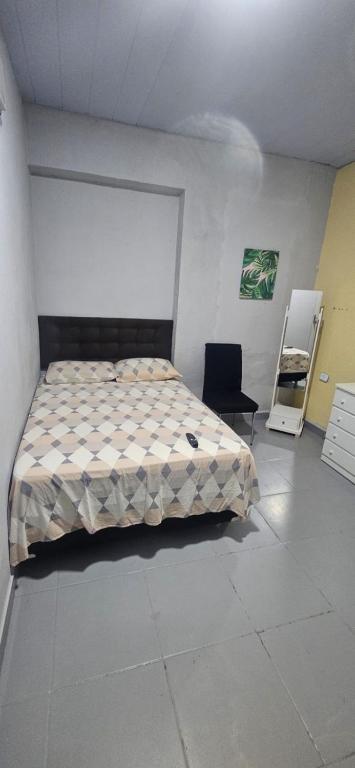 a bedroom with a bed and a chair in it at Quarto com otima localização in Manaus