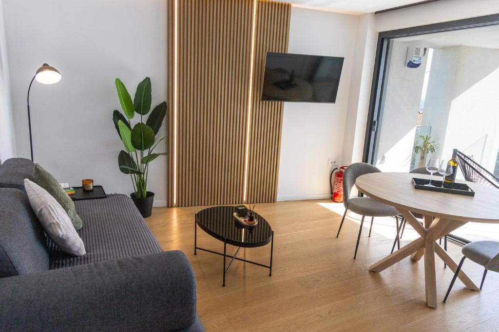 a living room with a couch and a table at The L Smart Suite - Premium & Minimal in Ierapetra