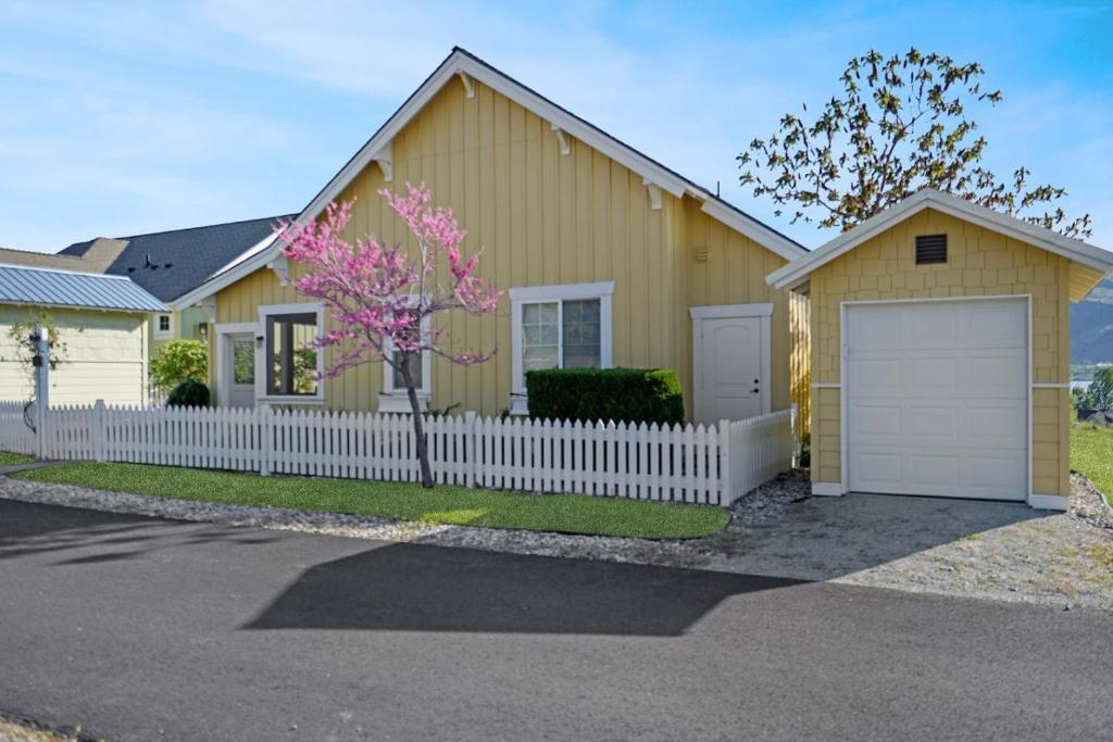 a yellow house with a white fence at Sunny Getaway at Veranda Beach in Oroville
