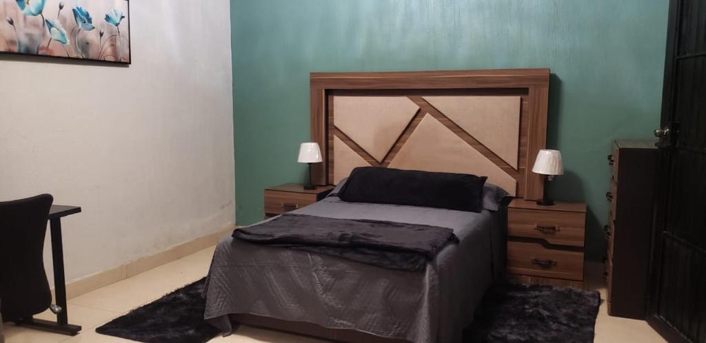 a bedroom with a bed and two nightstands and a bed sidx sidx sidx at Casa Tierra Mia in Tequila