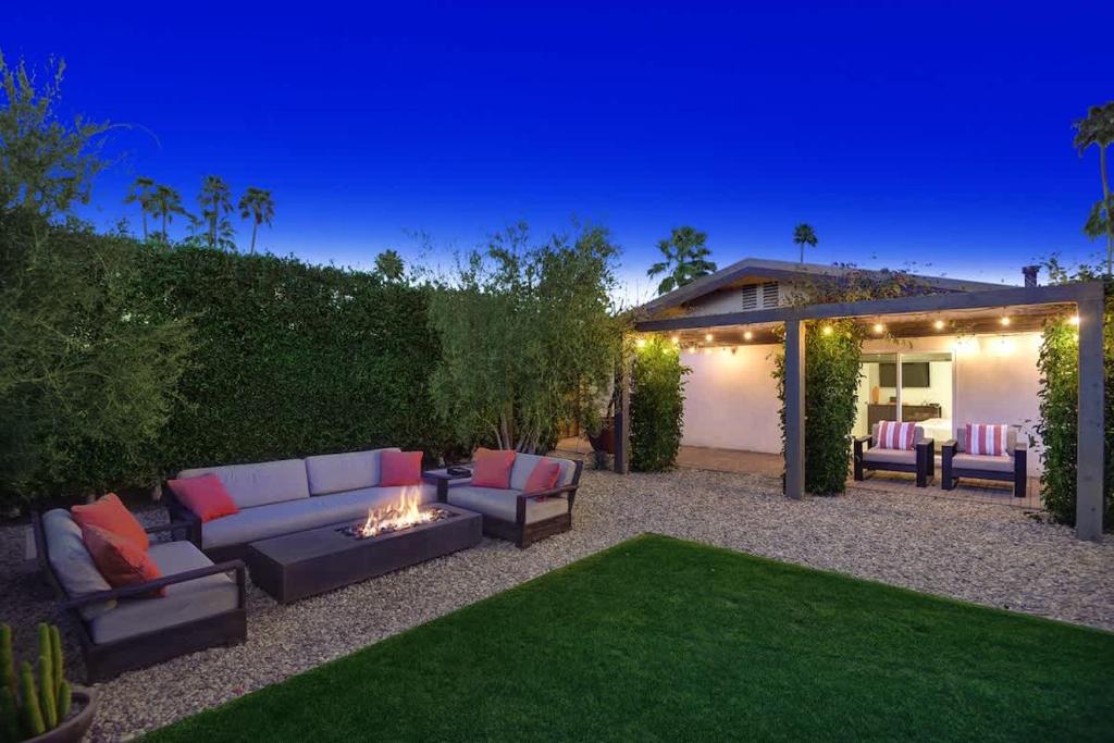 a backyard with a couch and chairs and a fire pit at Alejo Olive Orchard - Alice Lodging in Palm Springs