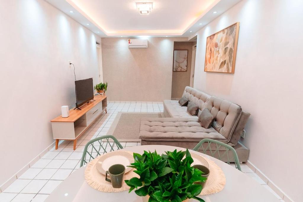 a living room with a couch and a table at REFÚGIO FAMILIAR Jampa JP in João Pessoa