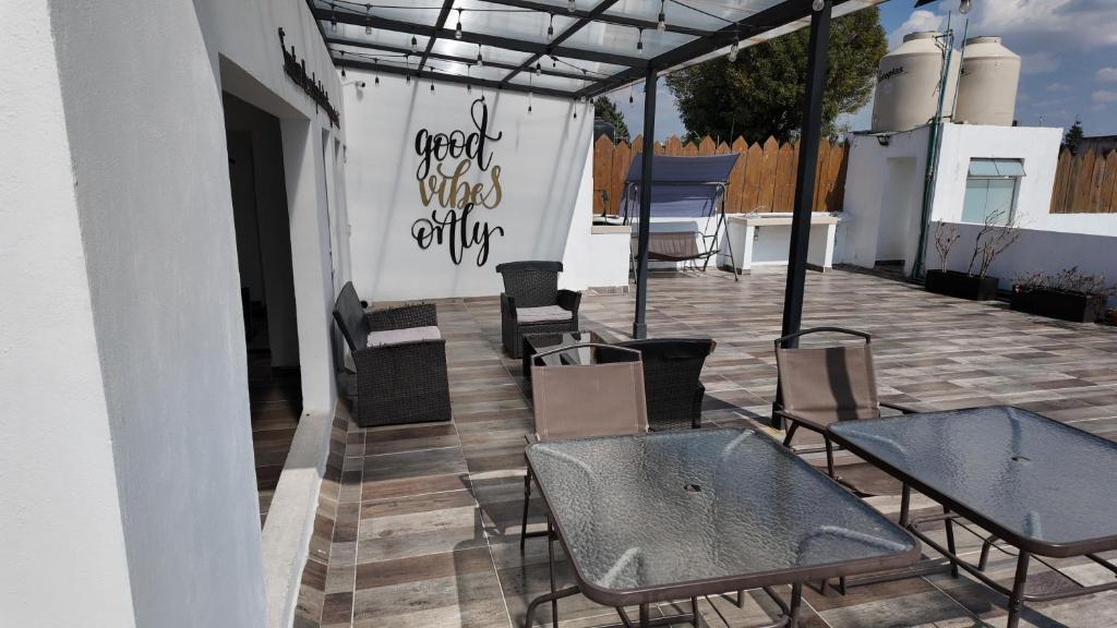 a group of chairs and tables on a patio at Living Up in Puebla