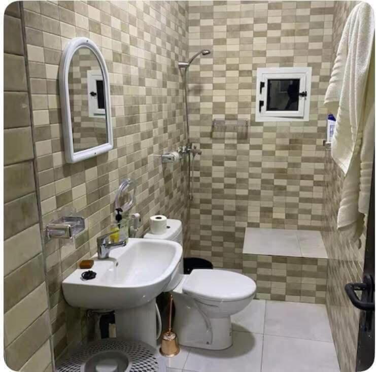 a bathroom with a sink and a toilet at ESSERa in Nouakchott