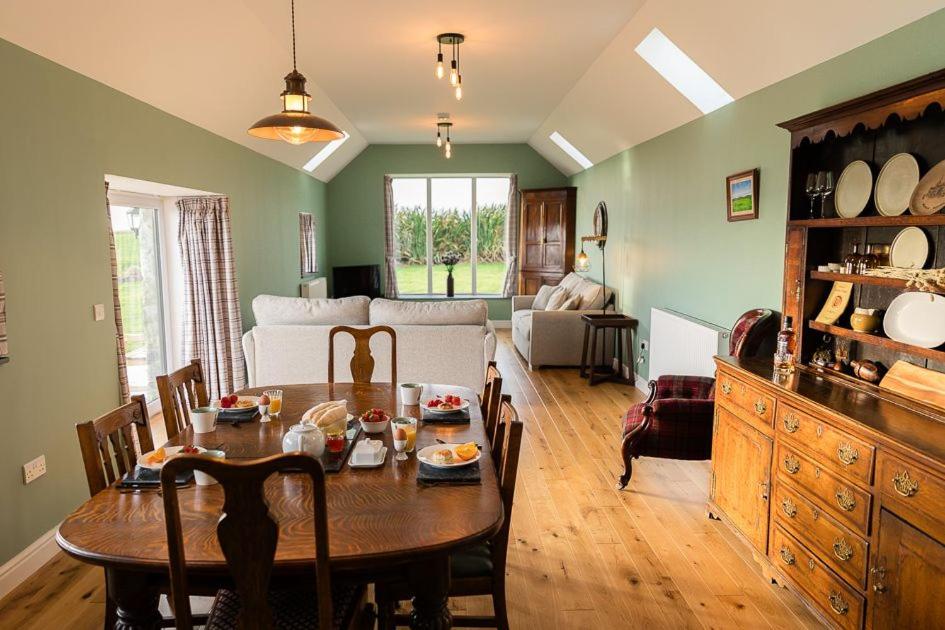 a living room with a dining room table and a couch at Dale, Burray, Orkney - OR00597F in Burray Village