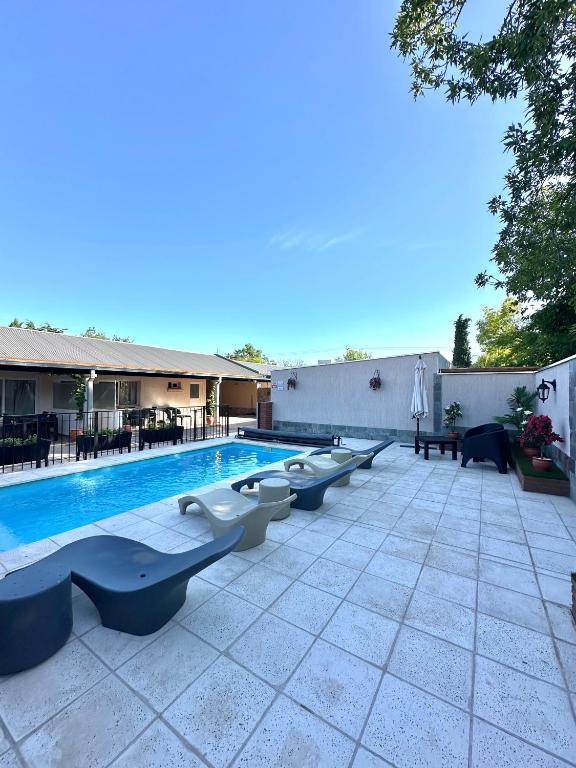 a swimming pool with benches next to a building at Etel in San Rafael