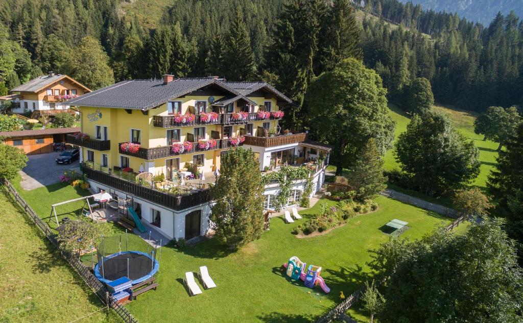 an aerial view of a house in the mountains at Hotel Sporthof Austria in Ramsau am Dachstein
