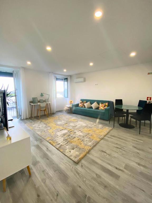 a living room with a couch and a table at Naval - Marina View Apartments in Vila do Conde