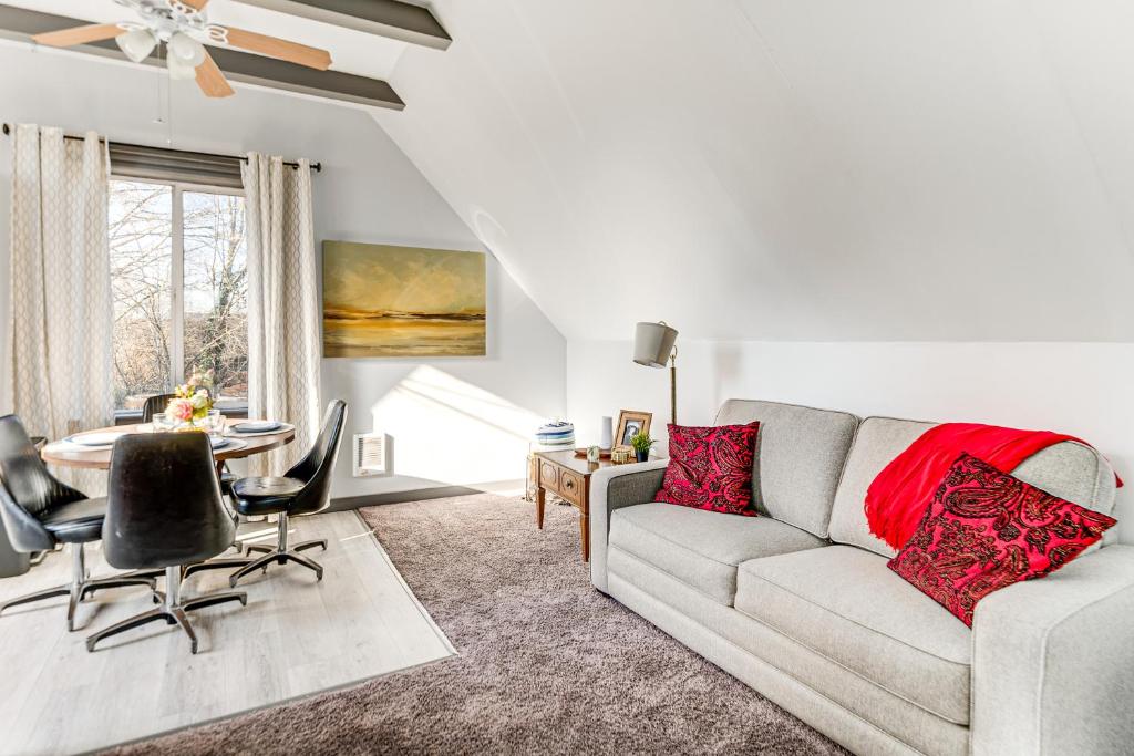 a living room with a couch and a table at Walkable Location, Historic Setting: Warrenton Apt in Warrenton