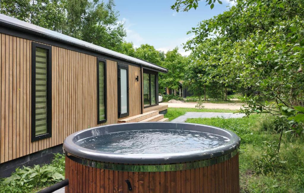 a large tub of water in front of a house at Sernets Recreatie Chalet 111 in Oud-Gastel