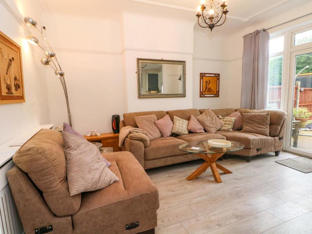 a living room with a couch and a table at Broadgreen in Liverpool